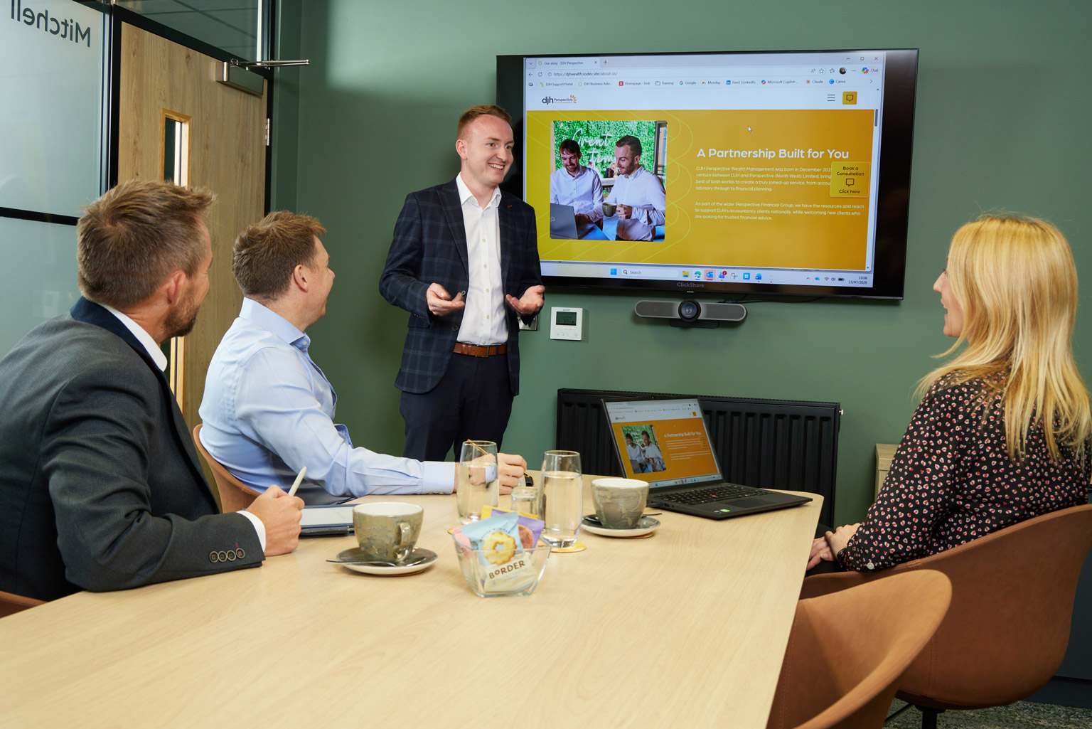 DJH Wealth Perspective Management advisers at a meeting